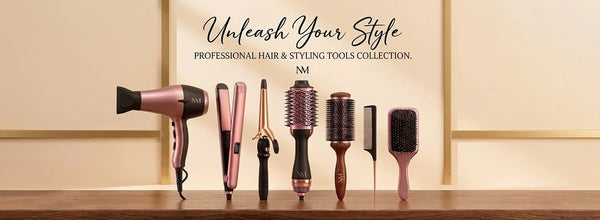 A wide-angle display of a professional hair and styling tools collection featuring a rose gold hair dryer, flat iron, and curling wand on a wooden surface against a minimalist cream background.