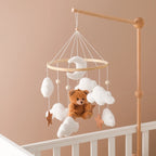 Wooden baby mobile by Nova Mart featuring a soft felt cartoon bear and music box for soothing nursery decor.