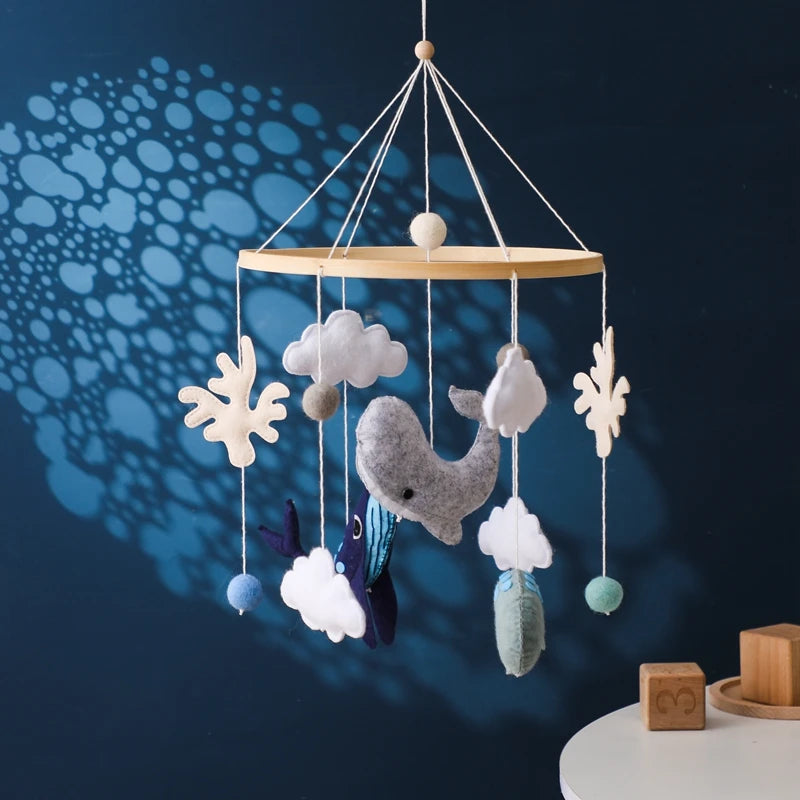 Wooden crochet stars baby crib mobile with bell rattle toy by Nova Mart hanging from a crib.
