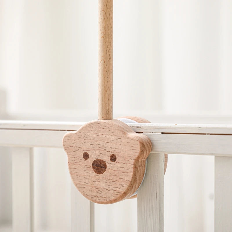 Baby wooden crib mobile with cloud-shaped hanging rattle toy and bracket, designed for infant cribs by Nova Mart.