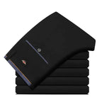 Men's slim fit black suit pants by Nova Mart, formal trousers with a tailored fit and classic design, shown on a model.