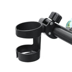Universal baby stroller cup holder by Nova Mart attached to a stroller, holding a bottle and drink for convenience.