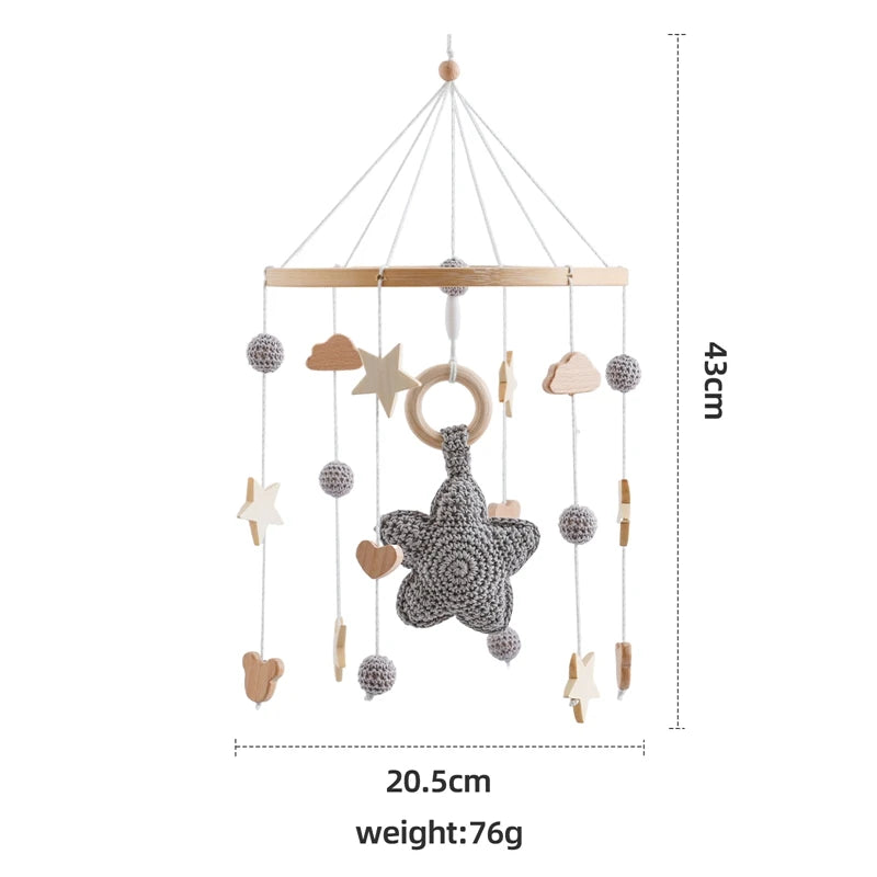 Wooden crochet star baby crib mobile with bell and rattle toy from Nova Mart, featuring colorful stars for soothing infant entertainment.