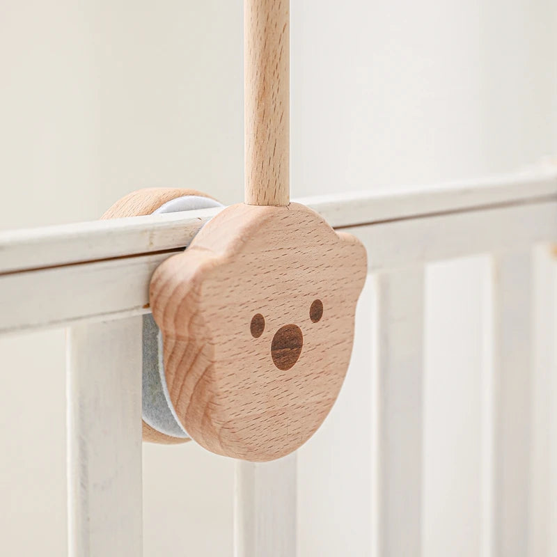 Baby wooden crib mobile with cloud-shaped hanging rattle toy and bracket, designed for nursery decor and soothing entertainment.