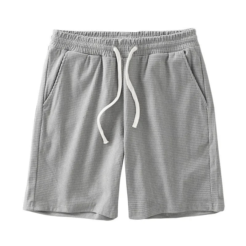 Men's navy waffle texture shorts with loose fit and drawstring waist, ideal for casual summer wear by Nova Mart