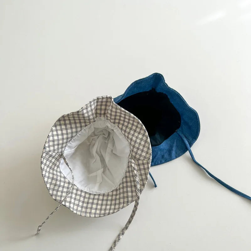 Baby bucket hat by Nova Mart with sunshade, fisherman style for infants and toddlers, shown in a soft fabric with wide brim.