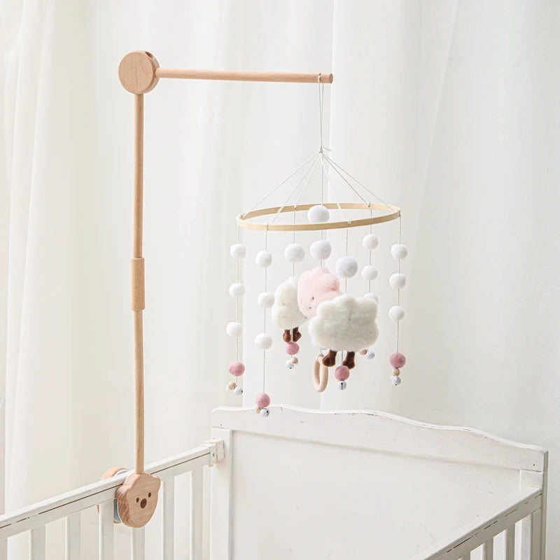 Baby wooden crib mobile with cloud-shaped hanging rattle toy and bracket, designed for nursery decor and infant entertainment.