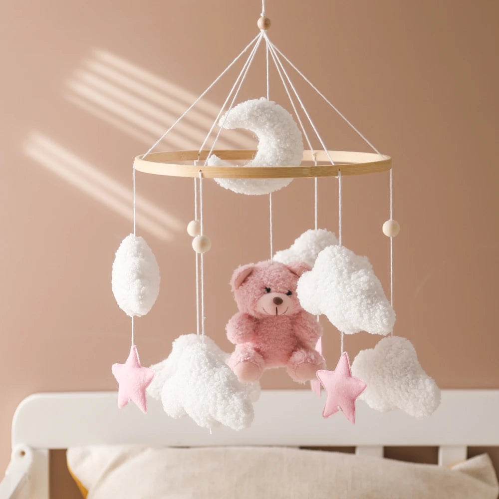 Wooden baby mobile with soft felt cartoon bear and music box, designed for nursery decor and infant entertainment.