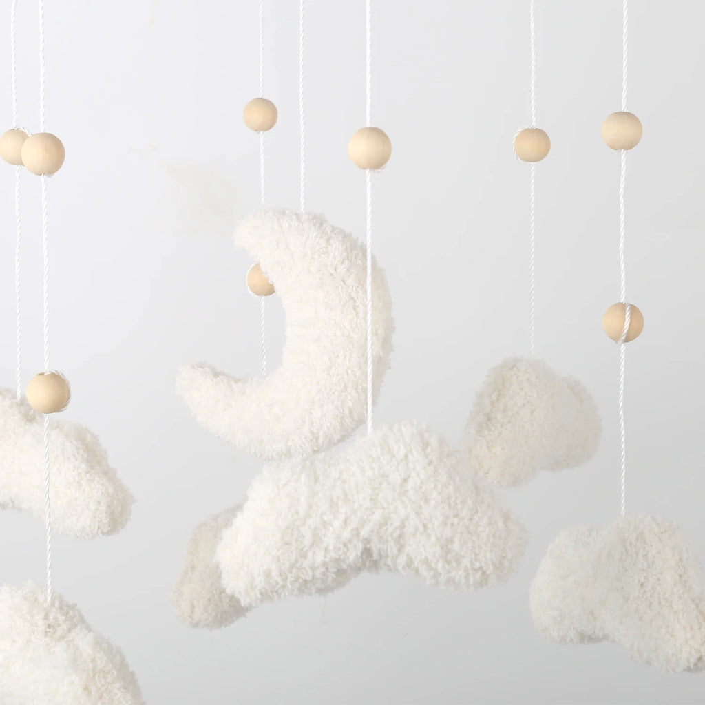 Neutral nursery felt baby mobile featuring boucle clouds and moon shapes, designed by Nova Mart for soothing baby toys.