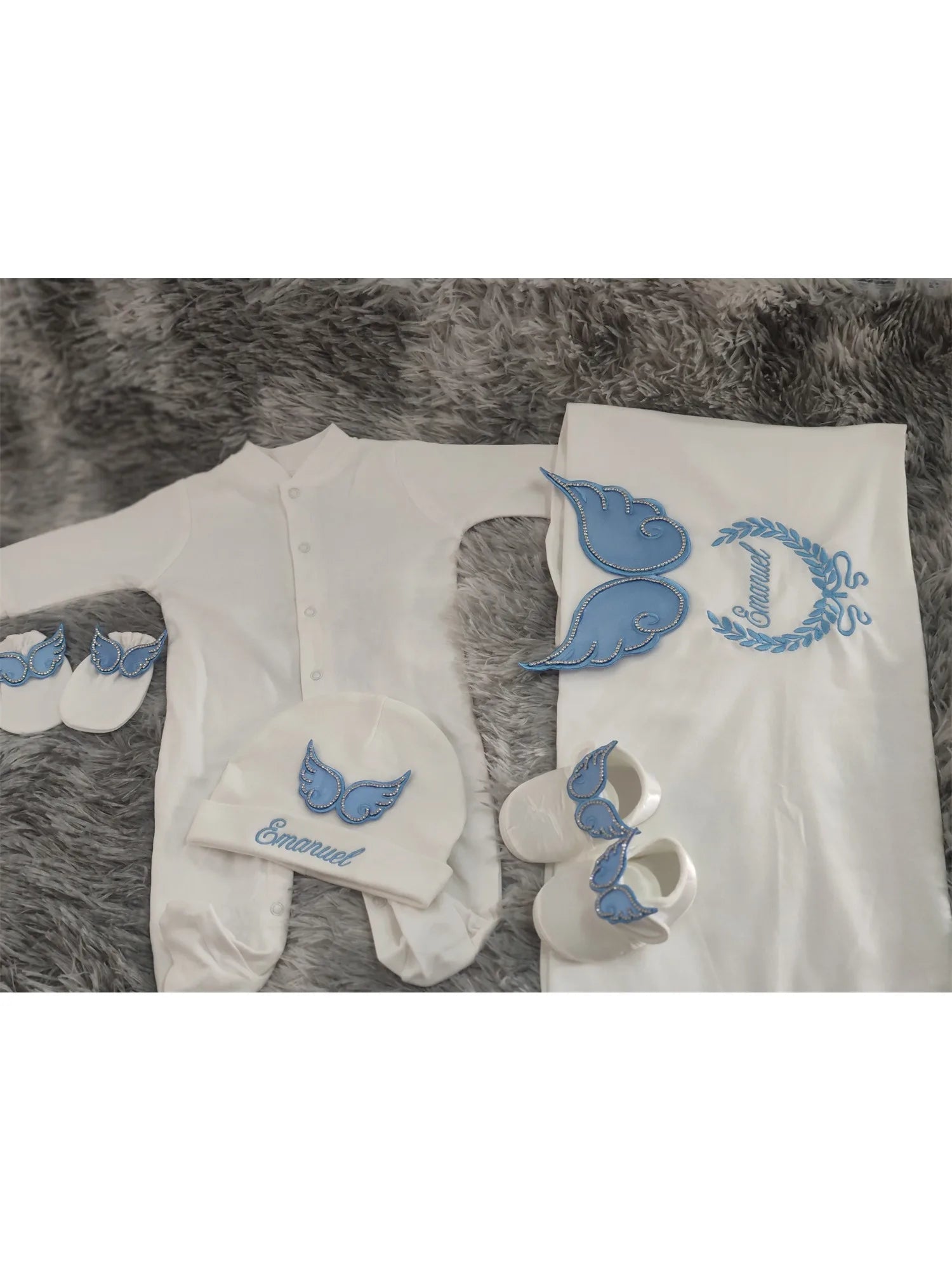 White and blue embroidered newborn angel wings outfit set from Nova Mart, featuring soft baby clothing and angel wing details.