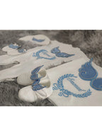 White and blue embroidered newborn angel wings outfit set for babies, made by Nova Mart, featuring soft baby clothing with angel wing details.