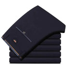 Men's slim fit black suit pants by Nova Mart, formal trousers with a tailored fit and classic style, shown on a model.