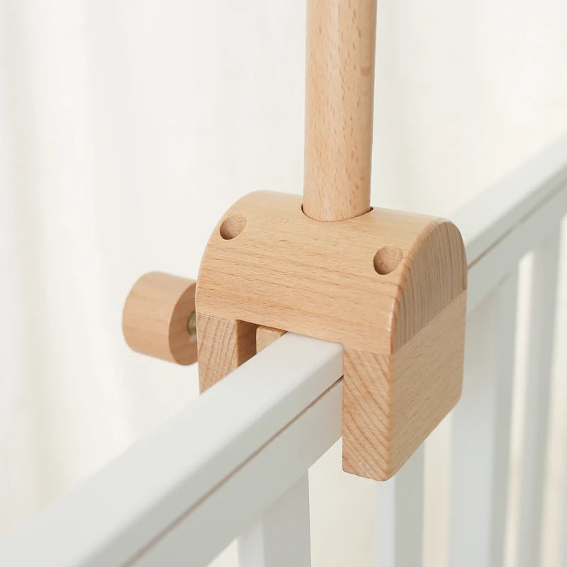 Baby wooden crib mobile with cloud-shaped hanging rattle toy and bracket, designed for infant cribs by Nova Mart.