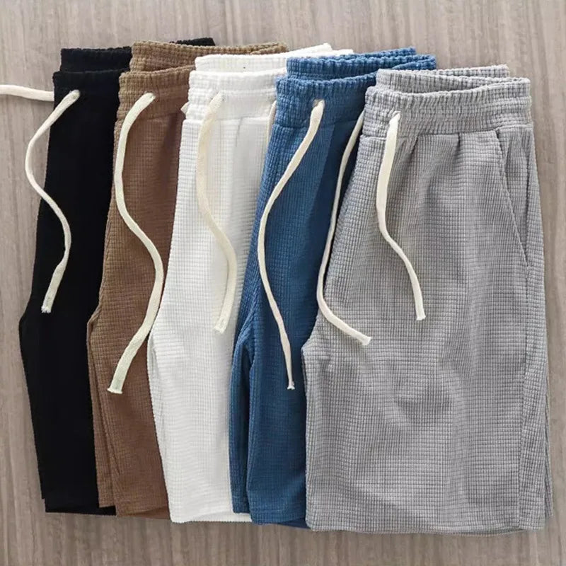 Men's casual summer shorts with waffle texture and drawstring, featuring a loose fit in navy blue from Nova Mart.