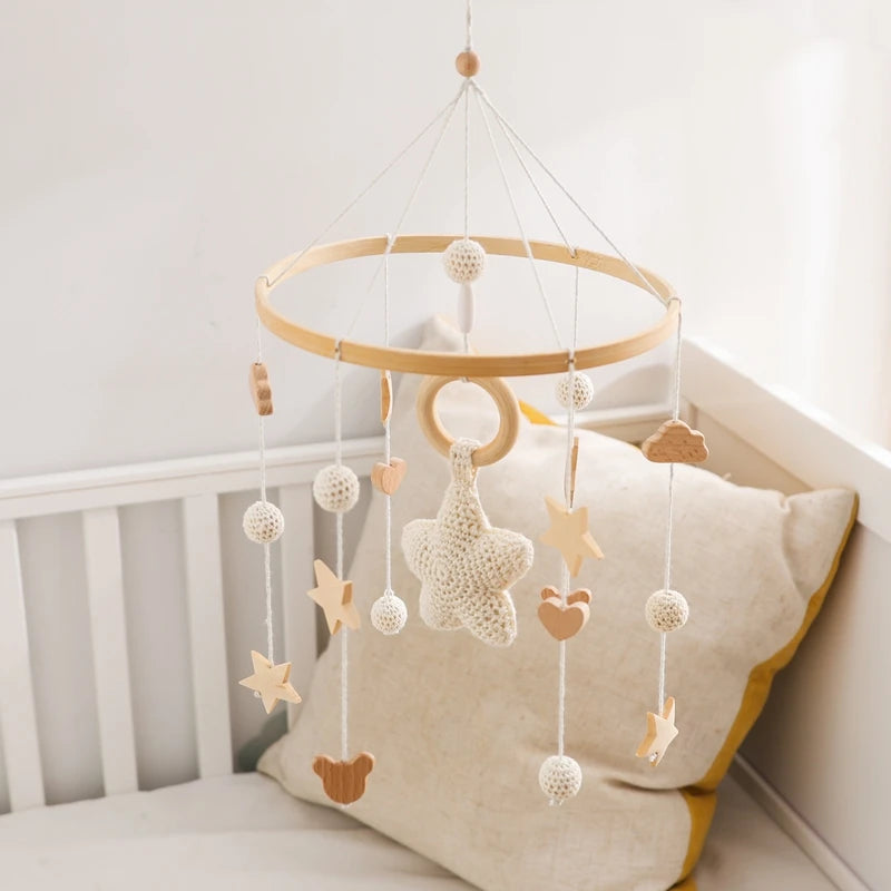 Wooden crochet stars baby crib mobile with bell rattle toy by Nova Mart, featuring soft crochet stars and a gentle hanging design.