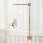 Baby wooden crib mobile with cloud-shaped hanging rattle toy and bracket, ideal for soothing infants in a nursery.