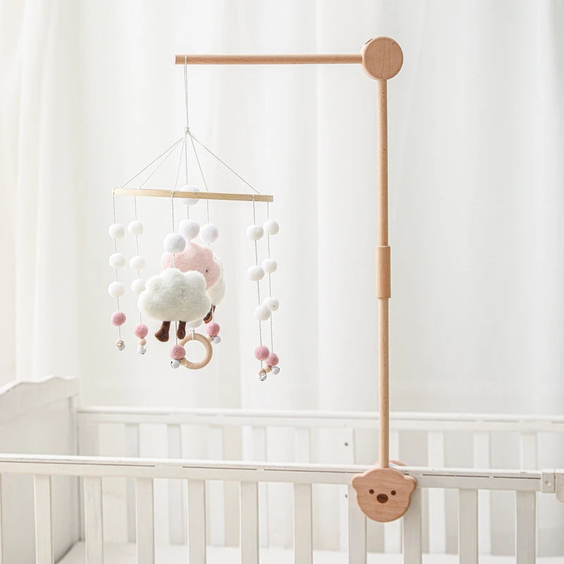 Baby wooden crib mobile with cloud-shaped hanging rattle toy and bracket, ideal for soothing infants in a nursery.