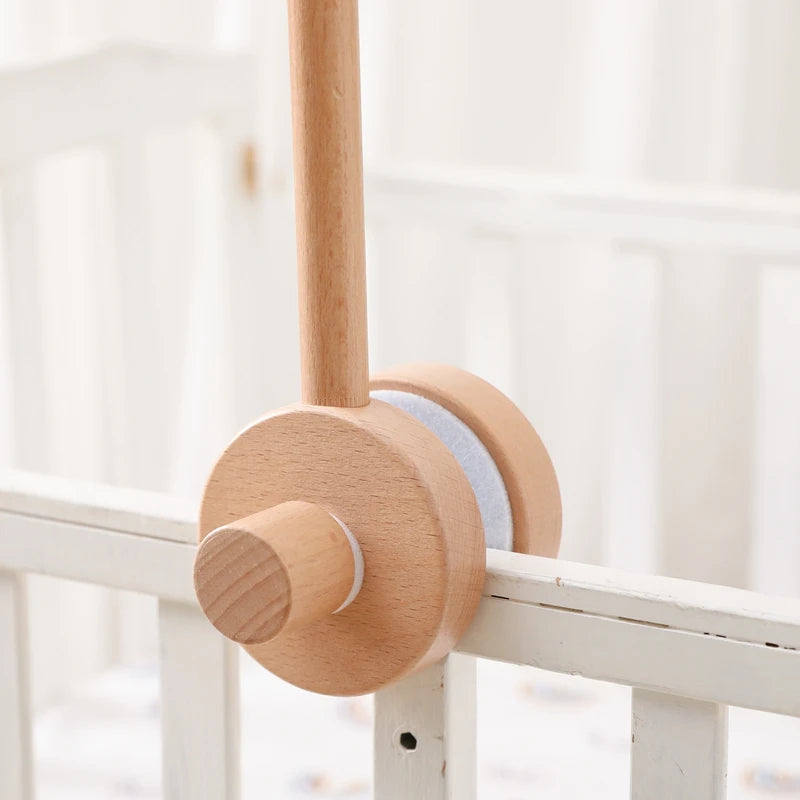 Wooden baby crib rattle toy with crochet bed bell bracket for infants aged 0-12 months, designed to entertain and soothe babies.
