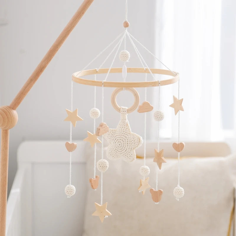 Wooden crochet star baby crib mobile with bell rattle toy by Nova Mart, featuring soft crochet stars and a hanging bell for infants.