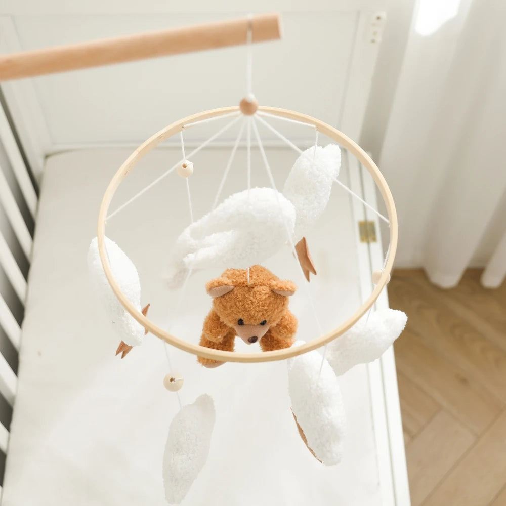Wooden baby crib mobile by Nova Mart featuring soft felt cartoon bear and a music box for calming nursery decor.