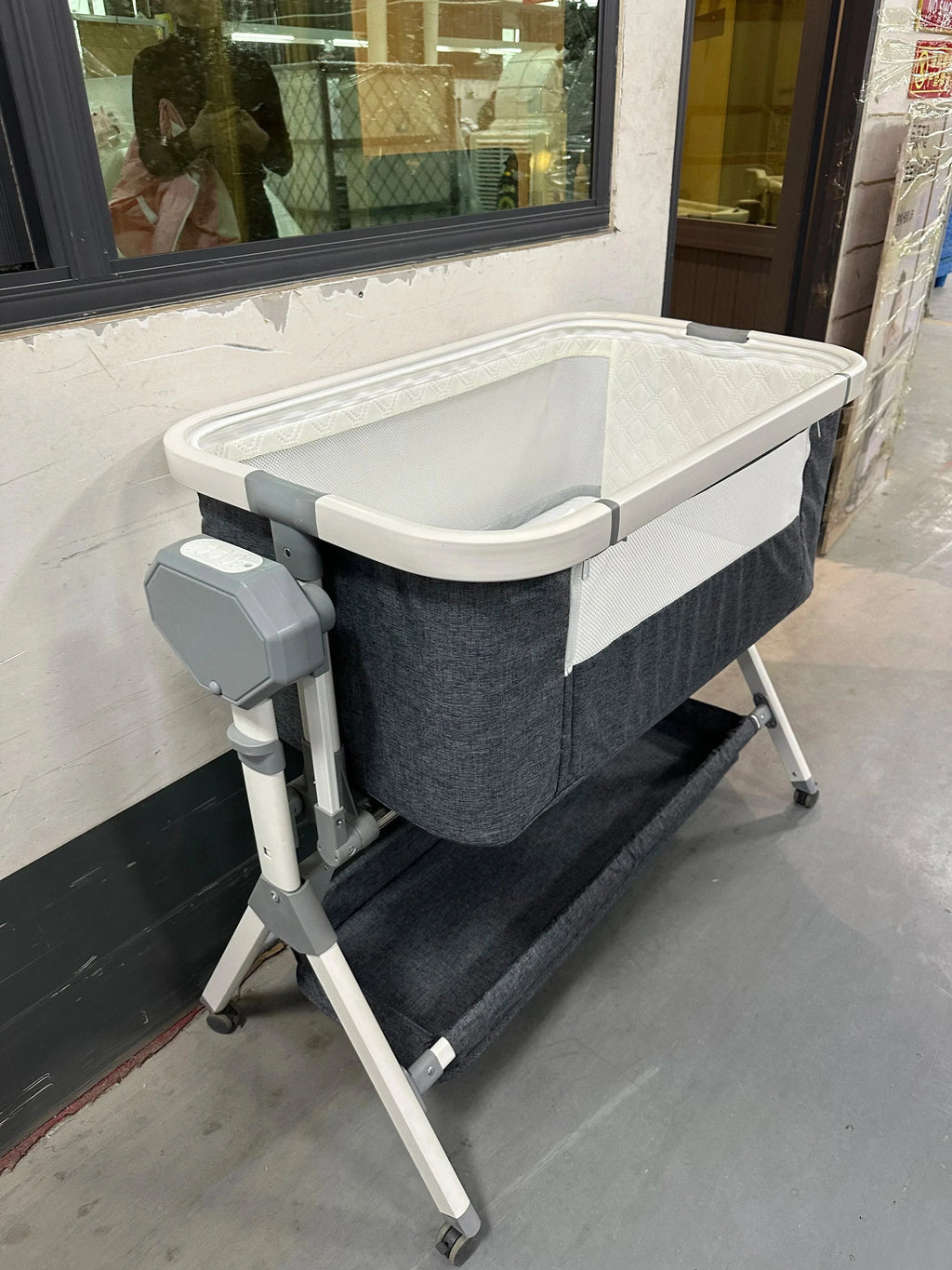 Automatic rocking baby bassinet by Nova Mart with built-in music and lights, designed for newborns.