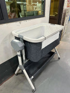 Automatic rocking baby bassinet by Nova Mart with built-in music and lights, designed for newborns.