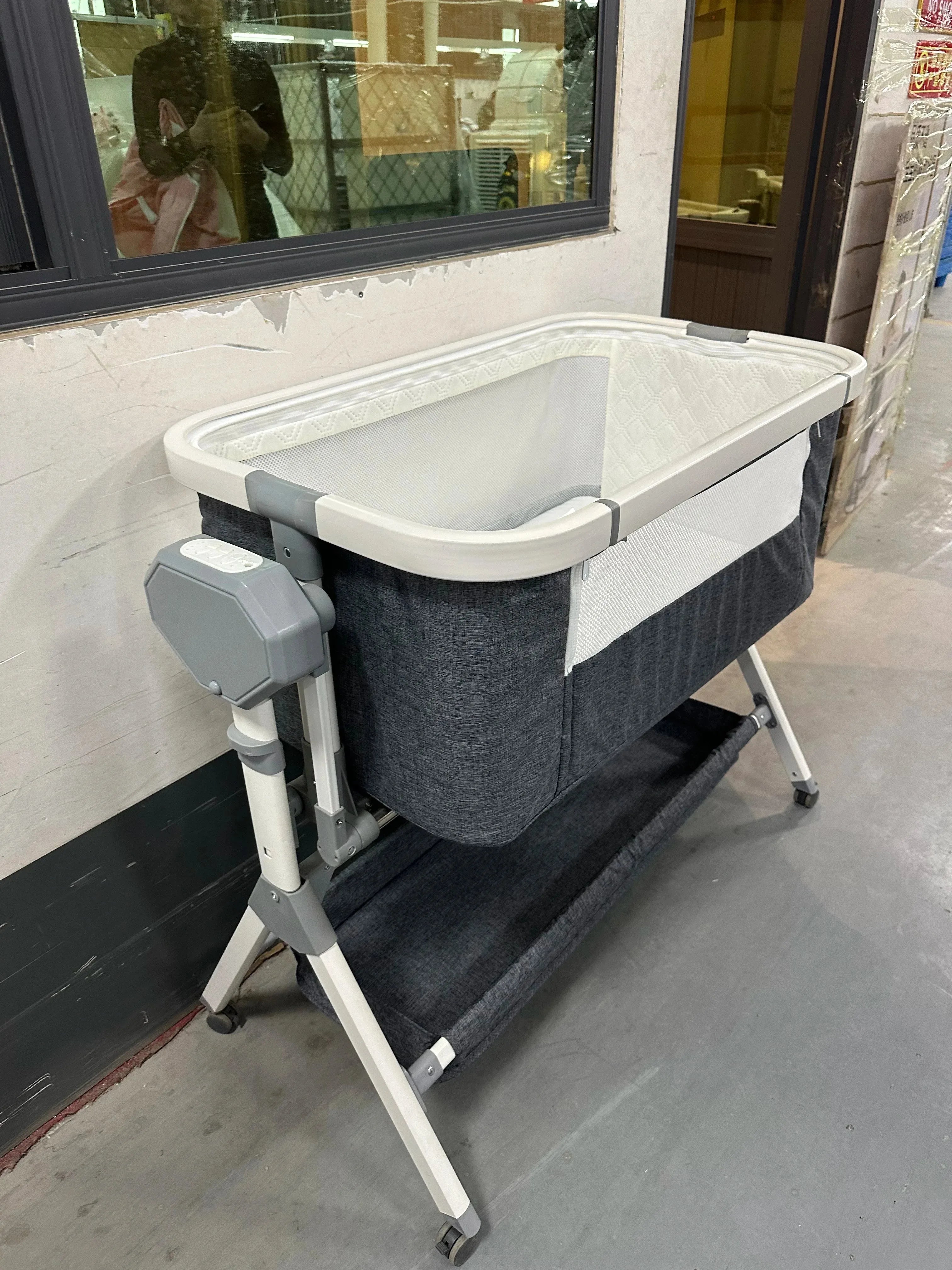 Automatic rocking baby bassinet by Nova Mart with built-in music and lights, designed for newborns.