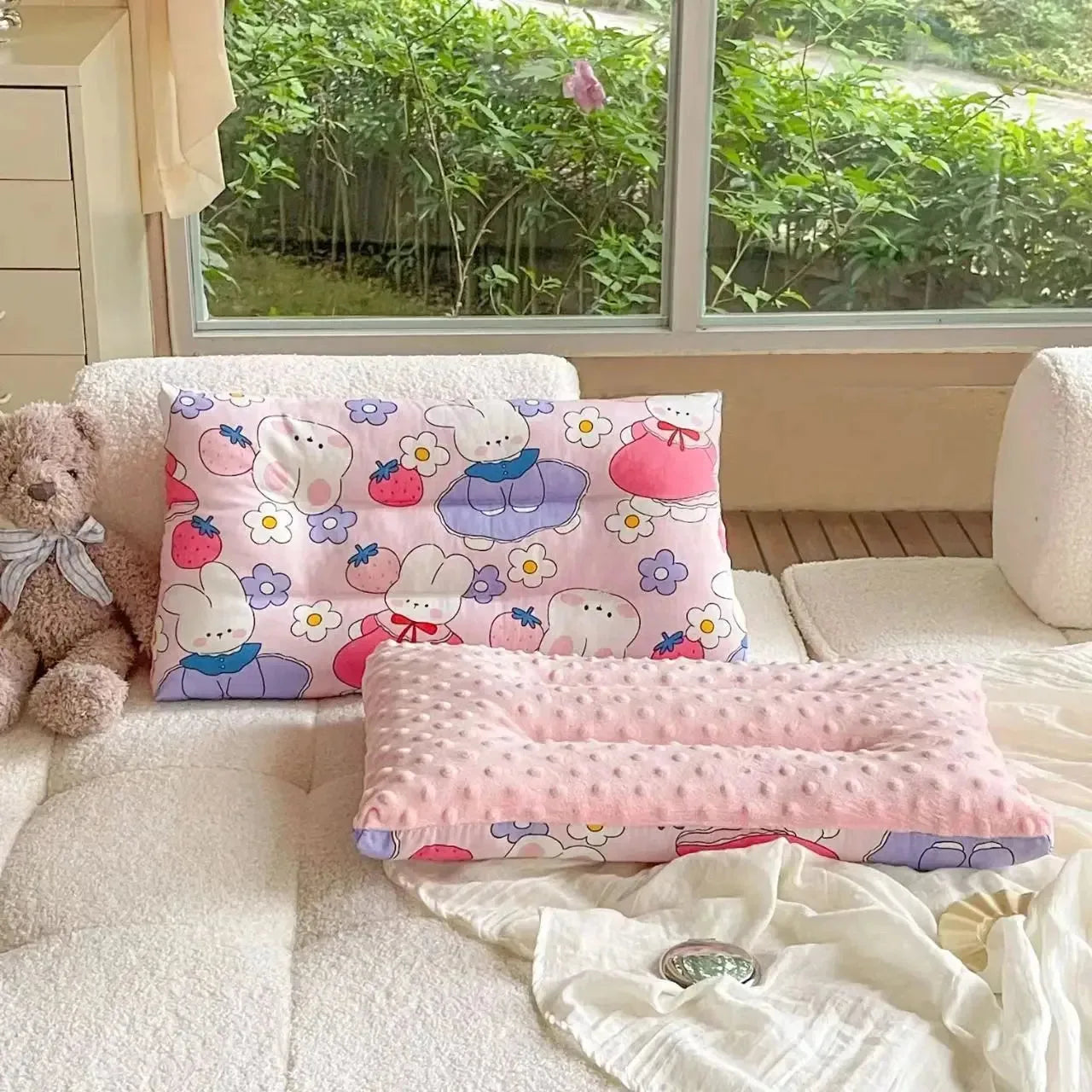 Baby sleep pillow from Nova Mart with soft cotton fabric, featuring cartoon design, removable and washable for comfortable baby bedding.
