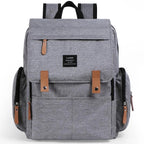 Nova Mart denim baby diaper bag backpack with thermal bottle pocket, featuring multiple compartments and adjustable straps.