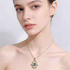 Silver evil eye Hamsa hand necklace for women featuring intricate design, symbolizing protection and good luck.