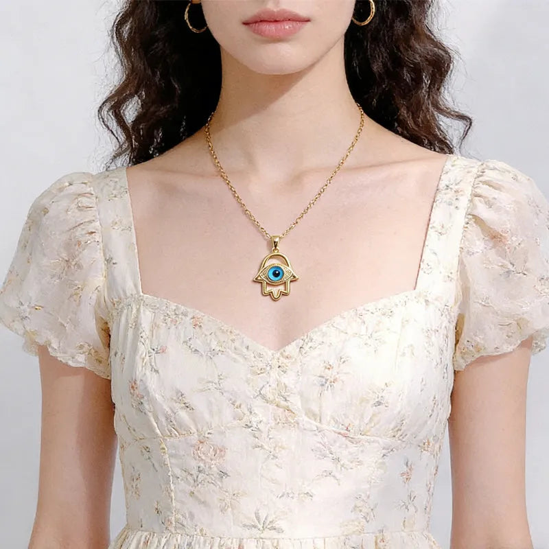 Silver Evil Eye Hamsa Hand necklace for women featuring a detailed evil eye design and protective charm.