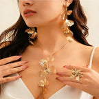 Gold leaf boho choker necklace with tassel pendant from Nova Mart, featuring intricate gold detailing and layered design.
