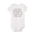 Baby boy wearing a short sleeve "Happy Birthday Daddy" Nova Mart baby bodysuit, summer romper with cheerful birthday theme.