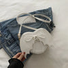 Heart-shaped bag with bat wing design, single shoulder crossbody style, by Nova Mart, featuring a unique strap and edgy details.
