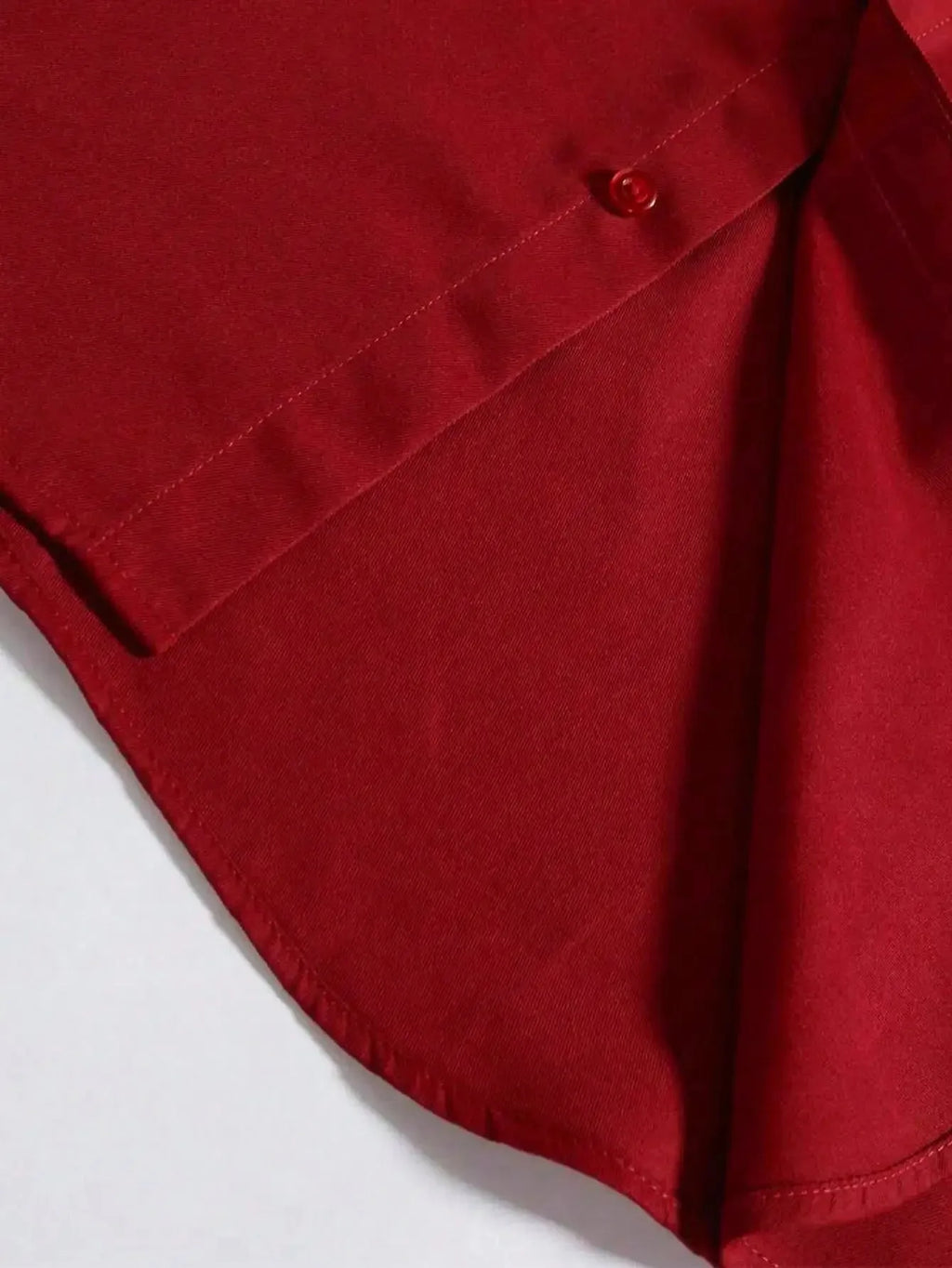 Men's red formal dress shirt with long sleeves, branded Nova Mart, shown on a hanger in a men's fashion display.
