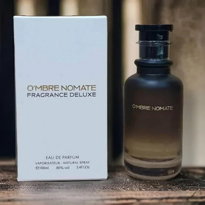 Ombre Nomate fragrance bottle and packaging on a wooden surface