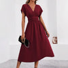Elegant solid-color women's long dress by Nova Mart, flowing fabric and classic style, shown in a full-length view.
