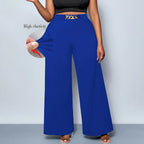 Plus size women's metal buckle trousers from Nova Mart, showing dark-colored pants with a prominent metal buckle detail.
