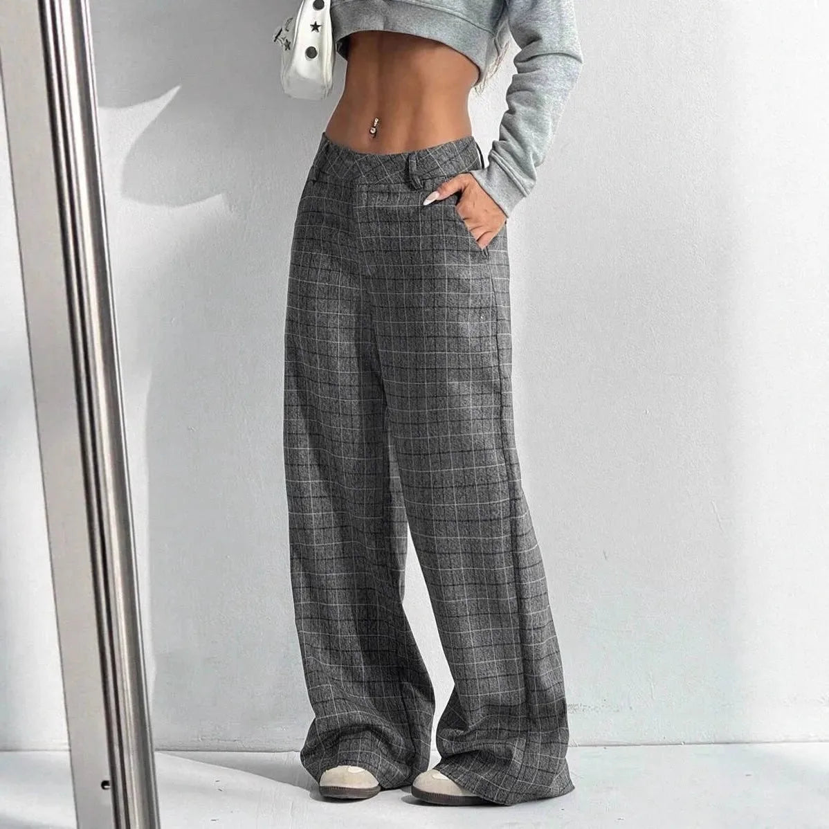 Women's printed plaid pants with pockets by Nova Mart, featuring a stylish pattern and comfortable fit.