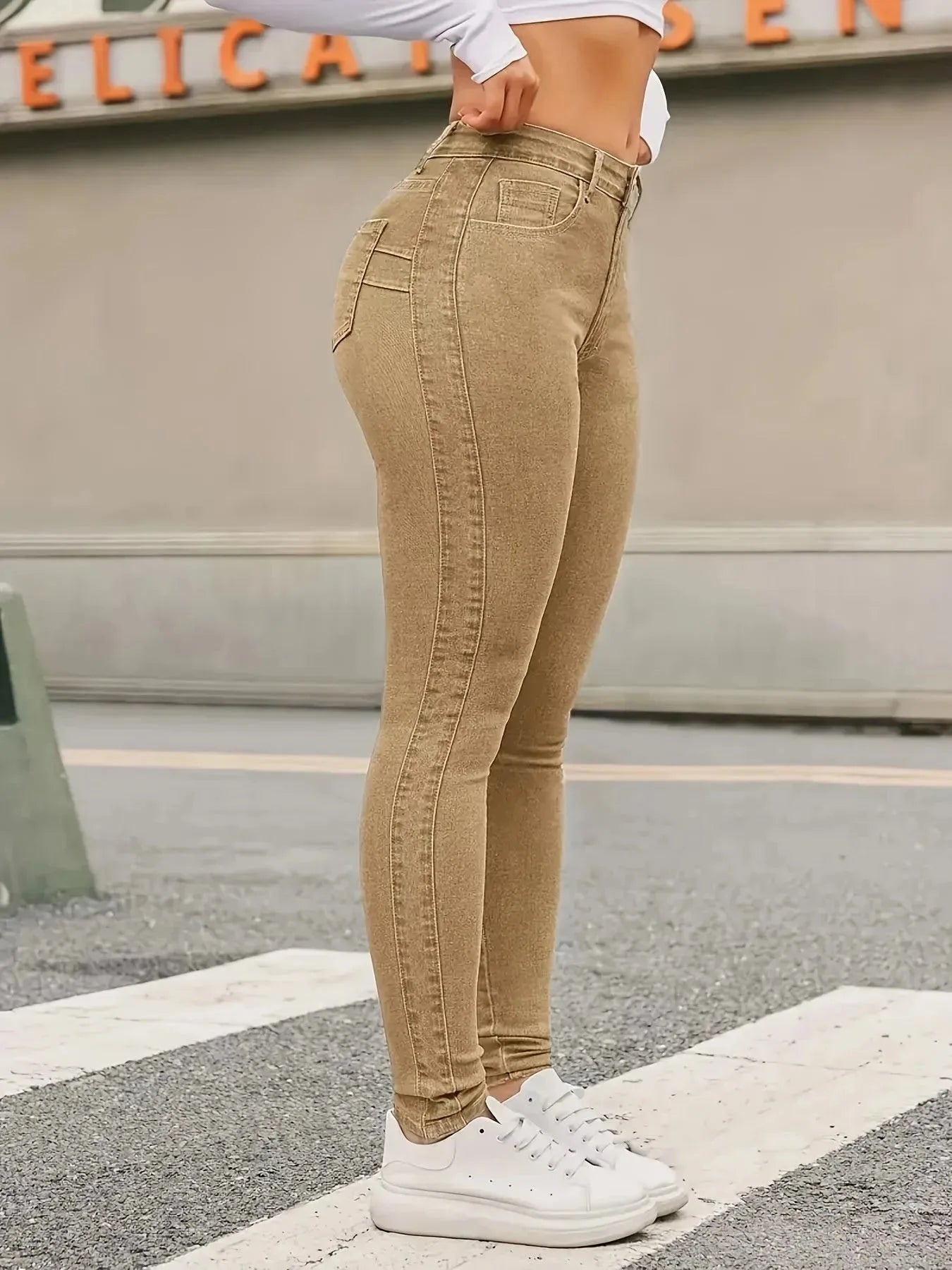 Women's skinny stretch jeans by Nova Mart, close-up of blue denim with fitted style and detailed stitching.