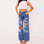 Women's distressed washed denim jeans by Nova Mart, showing a solid color design with ripped details and a classic fit.