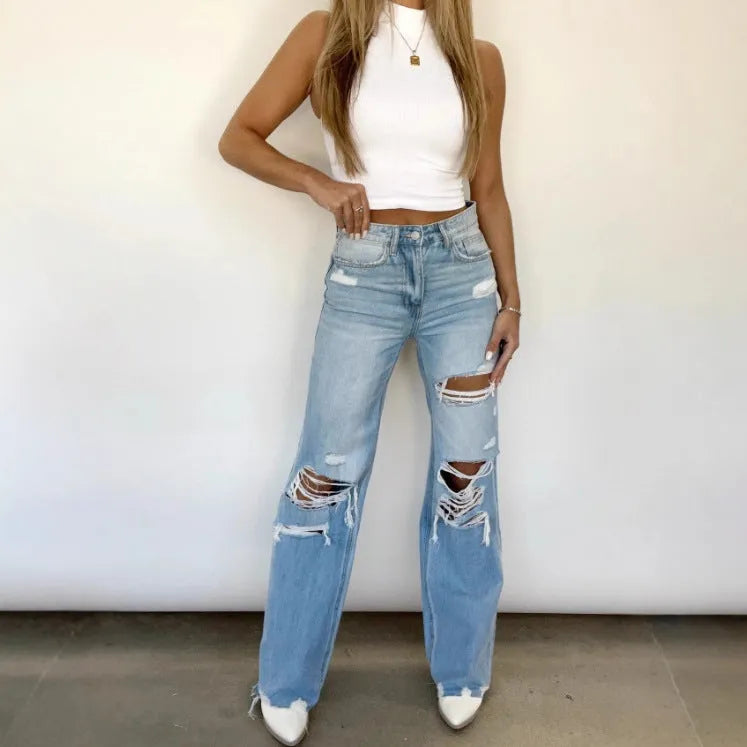 Women's distressed washed denim jeans by Nova Mart featuring solid color, ripped details, and a relaxed fit.