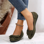 Plus size women's suede bow gommino flat shoes by Nova Mart, featuring a stylish bow detail and comfortable slip-on design.