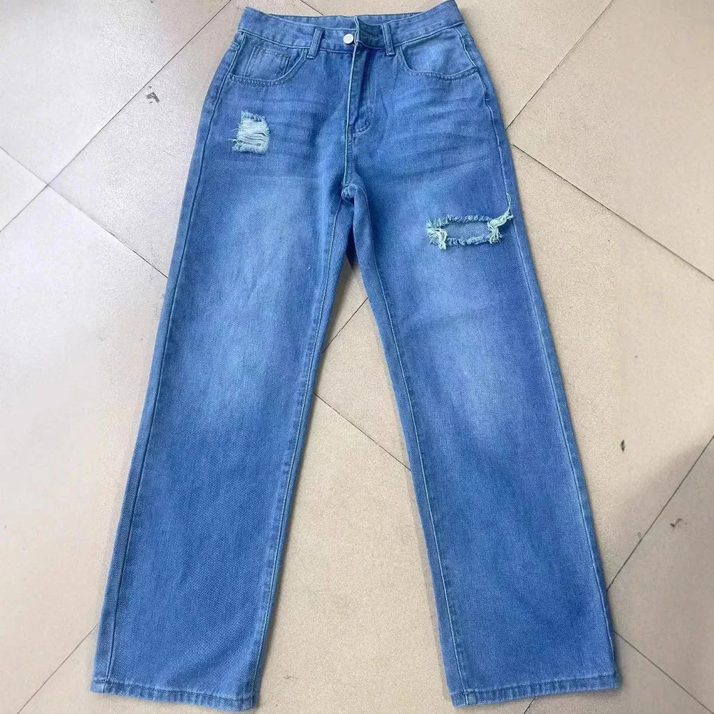 Women's washed ripped denim jeans by Nova Mart, stylish distressed jeans with a relaxed fit and trendy design.