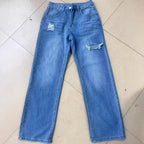 Women's washed ripped denim jeans by Nova Mart, stylish distressed jeans with a relaxed fit and trendy design.