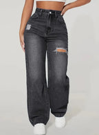 Women's washed ripped denim jeans by Nova Mart with distressed details and a relaxed fit, shown on a model.