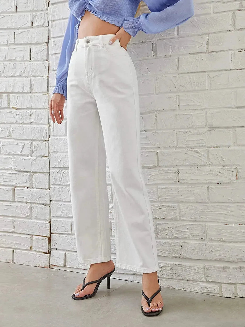 Women's washed straight-leg jeans by Nova Mart, showing fit and distressed denim details on a model.