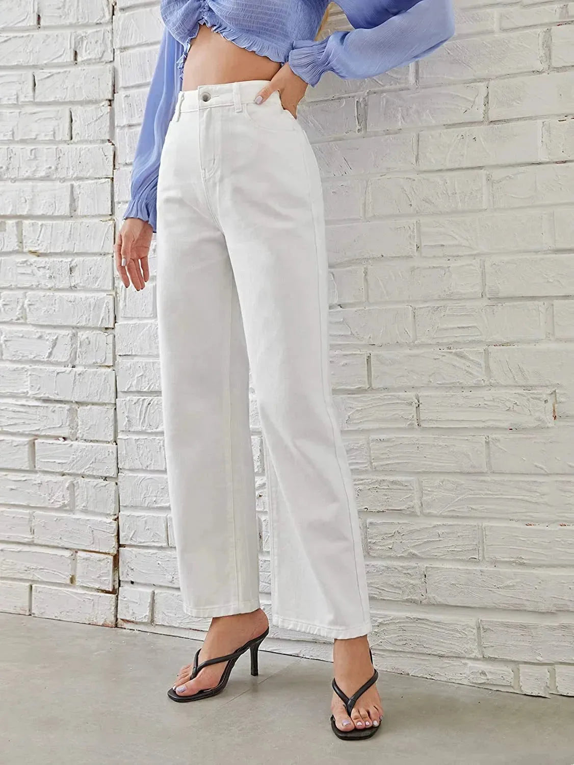 Women's washed straight-leg jeans by Nova Mart, showing fit and distressed denim details on a model.