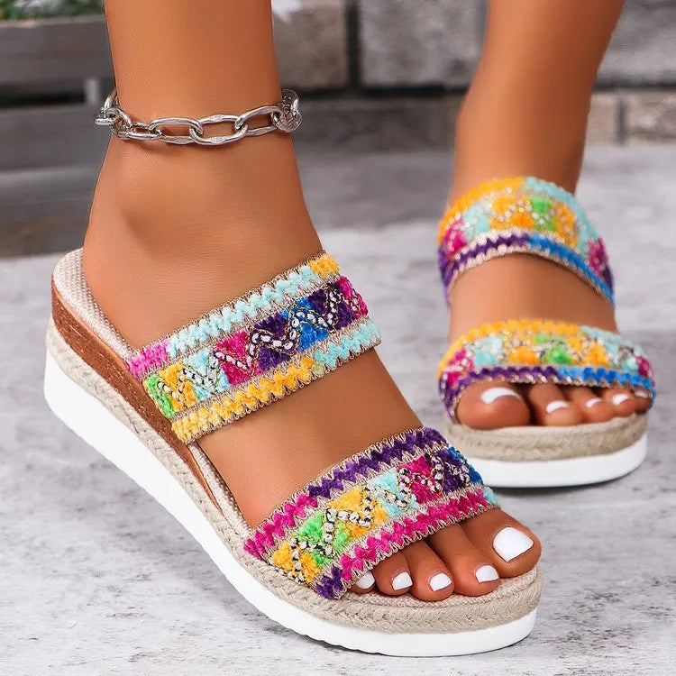Women's woven wedge sandals with ethnic style wide straps and a cork heel, by Nova Mart, shown on a model's feet.