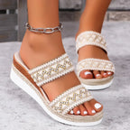 Women's woven wedge sandals with ethnic style wide straps, showing a natural tan color and stylish open-toe design.
